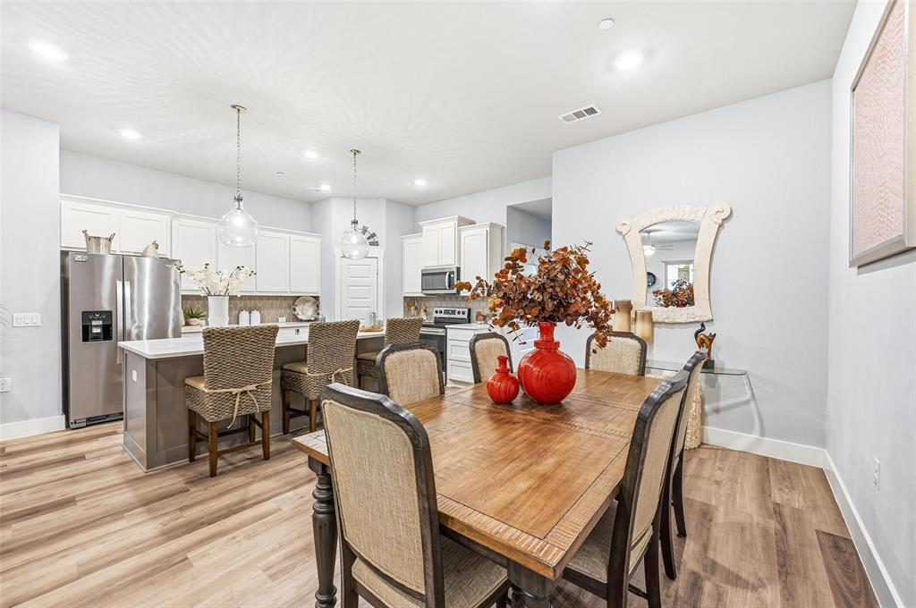 7236 Calistoga Lane Grand Prairie, TX 75054 - Photo 11 of 40 a view of a dining room with furniture and wooden floor
