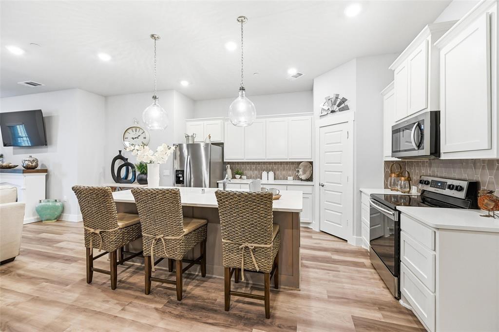 7236 Calistoga Lane Grand Prairie, TX 75054 - Photo 14 of 40 a view of a dining room with furniture a kitchen and chandelier