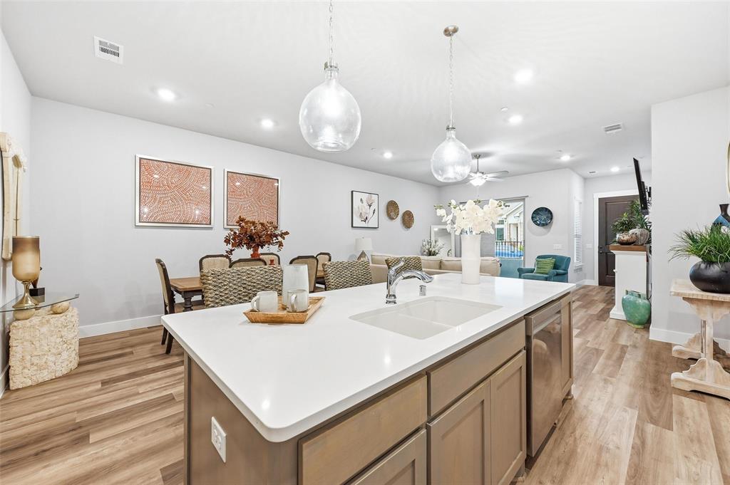 7236 Calistoga Lane Grand Prairie, TX 75054 - Photo 18 of 40 a view of kitchen island a sink and a chandelier