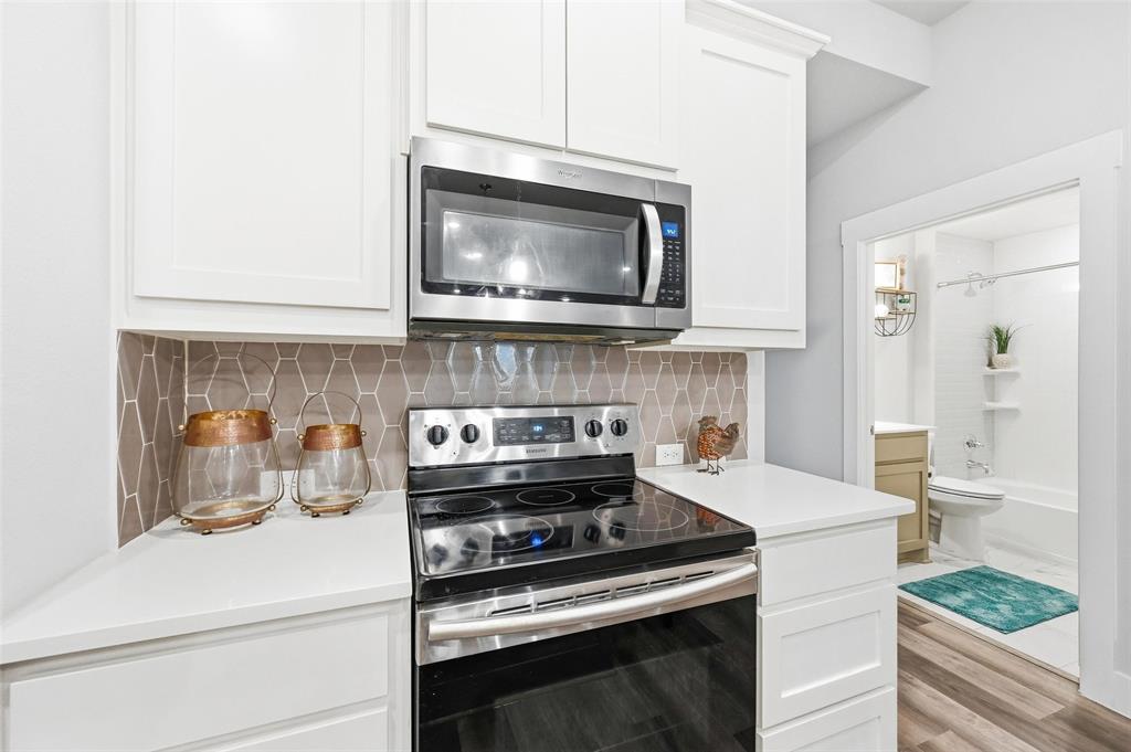 7236 Calistoga Lane Grand Prairie, TX 75054 - Photo 22 of 40 a kitchen with a stove and a microwave