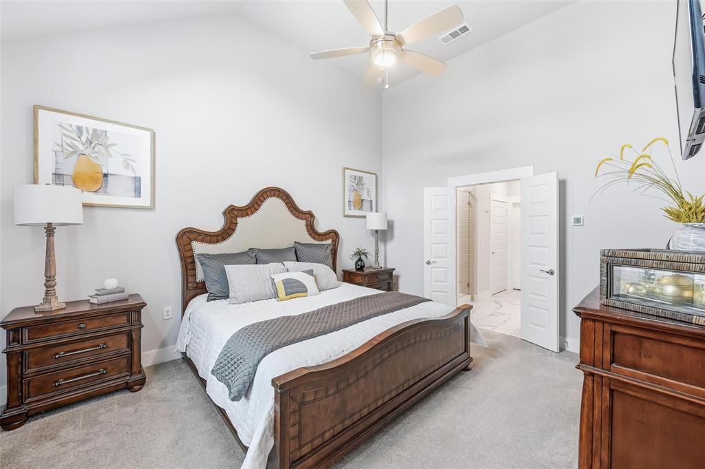 7236 Calistoga Lane Grand Prairie, TX 75054 - Photo 23 of 40 a bedroom with bed and a chandelier