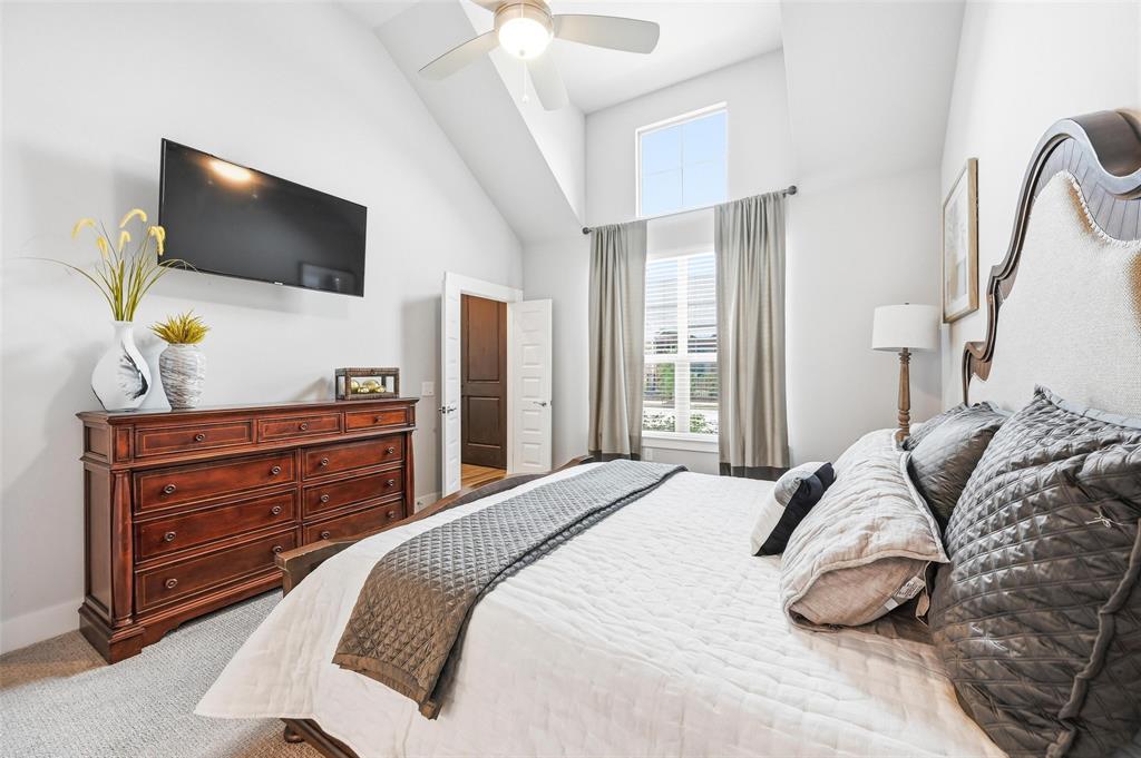7236 Calistoga Lane Grand Prairie, TX 75054 - Photo 26 of 40 a bedroom with a bed and flat screen tv