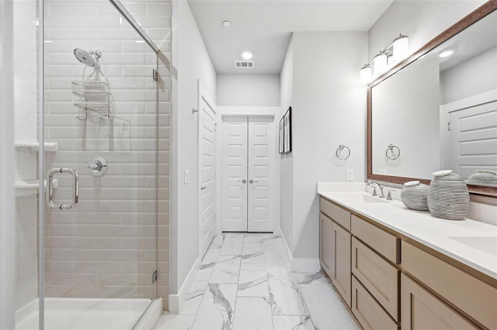 7236 Calistoga Lane Grand Prairie, TX 75054 - Photo 27 of 40 a bathroom with a double vanity sink a toilet and shower