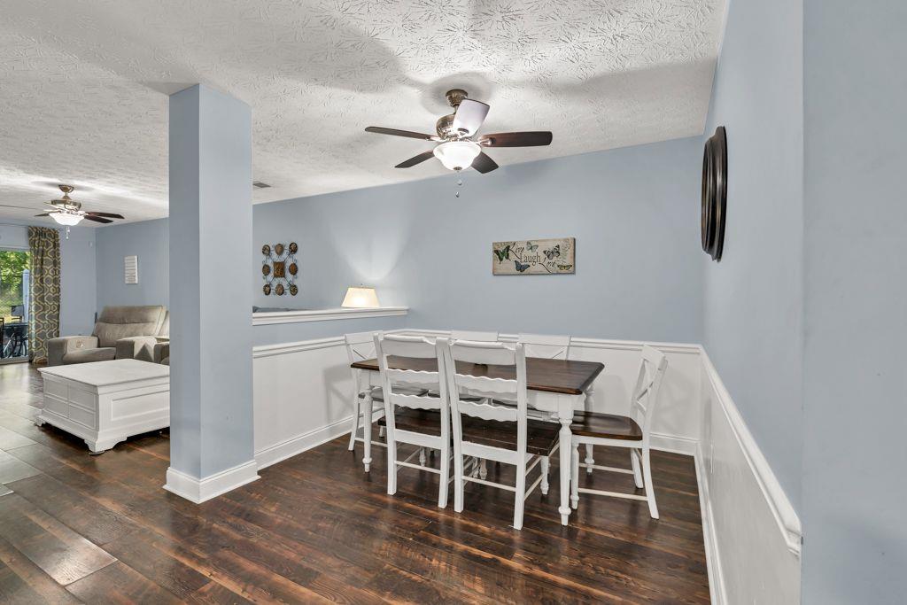 233 Tara Commons Walk Loganville, GA 30052 - Photo 15 of 52 a view of a dining room with furniture and wooden floor