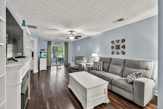 a living room with furniture flat screen tv and a fireplace