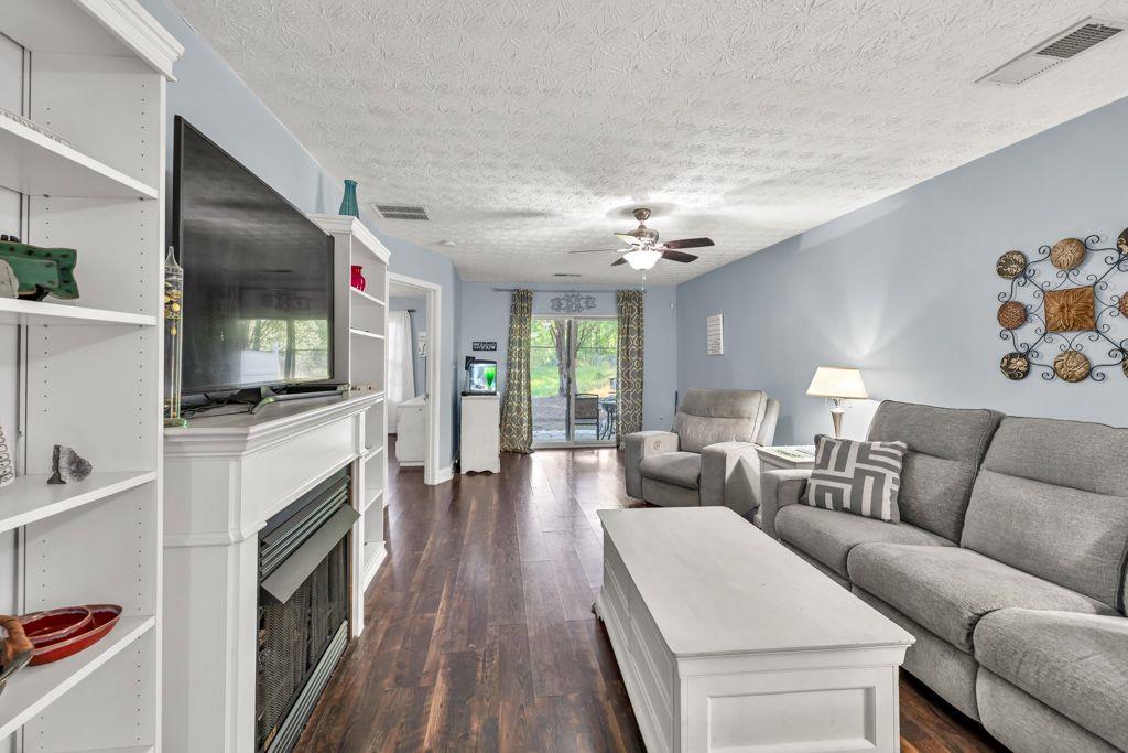 233 Tara Commons Walk Loganville, GA 30052 - Photo 17 of 52 a living room with furniture flat screen tv and a fireplace