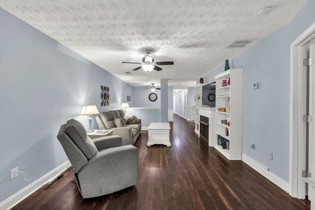 a living room with furniture and a wooden floor