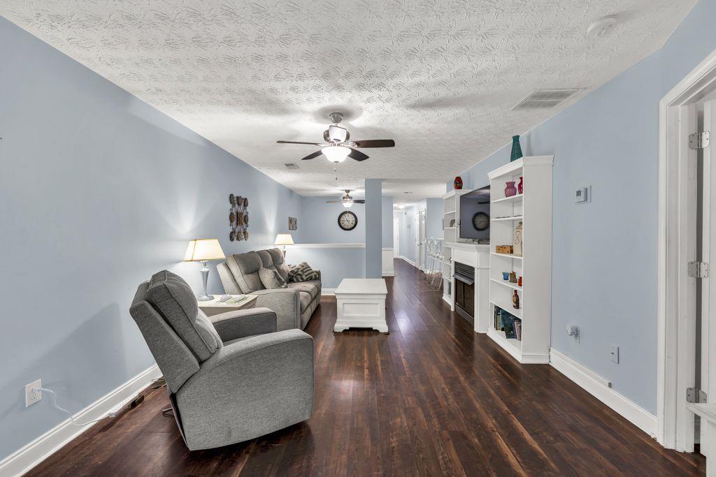 233 Tara Commons Walk Loganville, GA 30052 - Photo 18 of 52 a living room with furniture and a wooden floor
