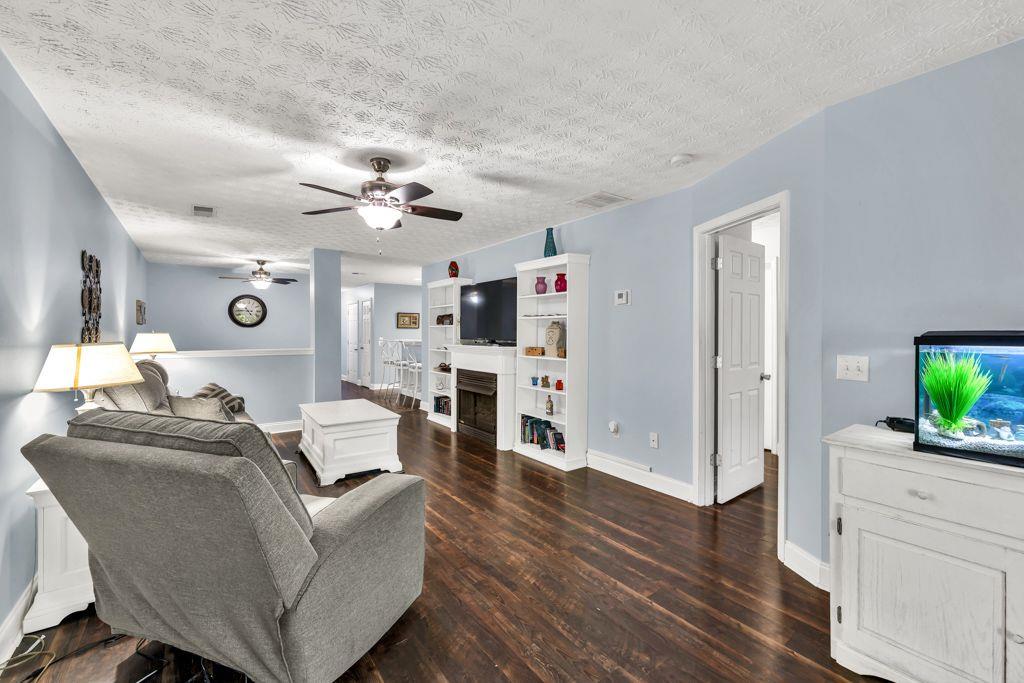 233 Tara Commons Walk Loganville, GA 30052 - Photo 19 of 52 a living room with furniture and a wooden floor