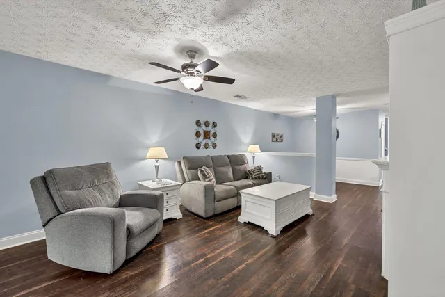 a bedroom with a bed and a flat tv screen on dresser