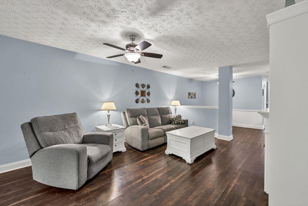 233 Tara Commons Walk Loganville, GA 30052 - Photo 20 of 52 a living room with couches and a view of kitchen