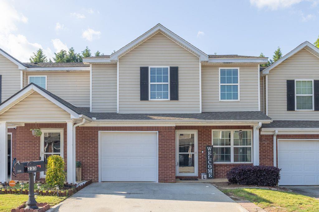 233 Tara Commons Walk Loganville, GA 30052 - Photo 2 of 52 a view of a house with wooden walls and potted plants