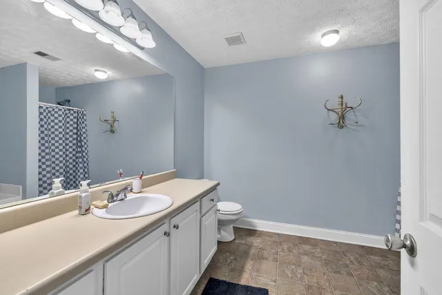 a white bath tub sitting next to a white cabinet