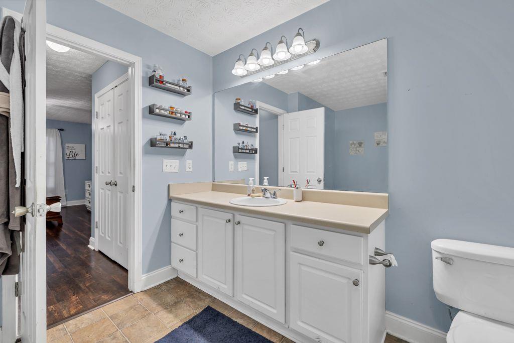 233 Tara Commons Walk Loganville, GA 30052 - Photo 27 of 52 a spacious bathroom with a toilet sink and mirror