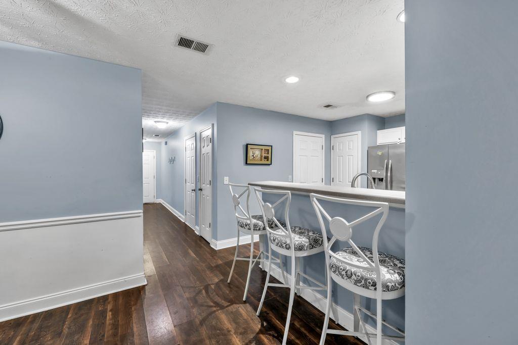 233 Tara Commons Walk Loganville, GA 30052 - Photo 28 of 52 a view of a dining room with furniture and wooden floor