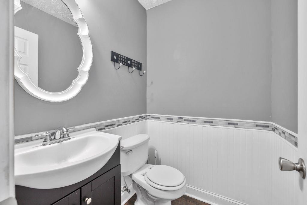 233 Tara Commons Walk Loganville, GA 30052 - Photo 30 of 52 a bathroom with a sink a toilet and a mirror