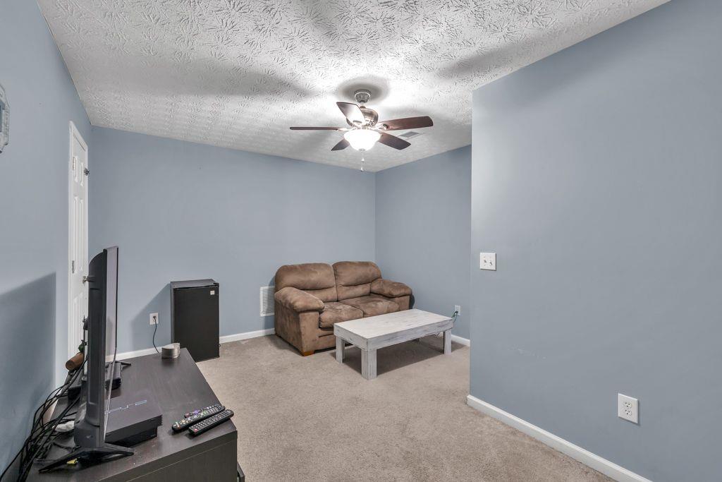 233 Tara Commons Walk Loganville, GA 30052 - Photo 31 of 52 a bedroom with furniture and a ceiling fan