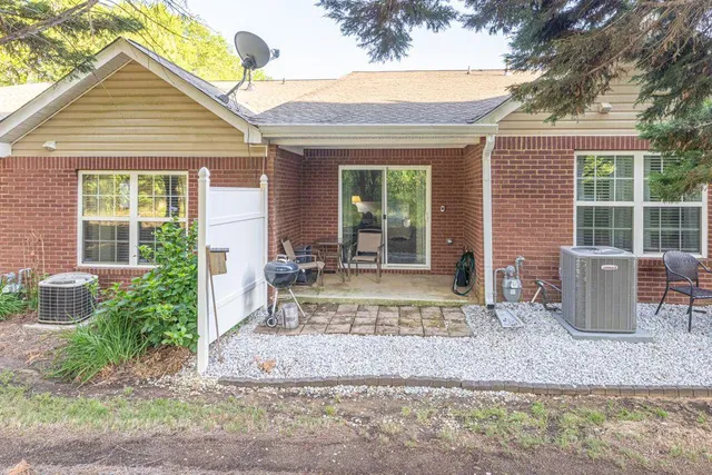 a front view of a house with garden and seating space