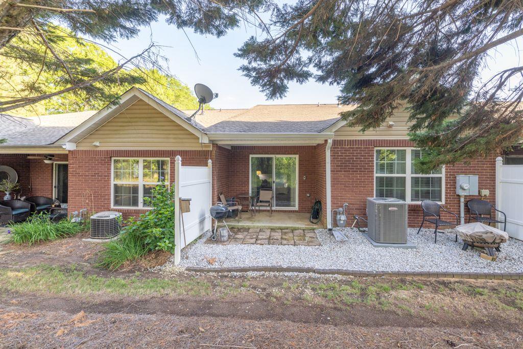 233 Tara Commons Walk Loganville, GA 30052 - Photo 41 of 52 a front view of a house with garden and seating space