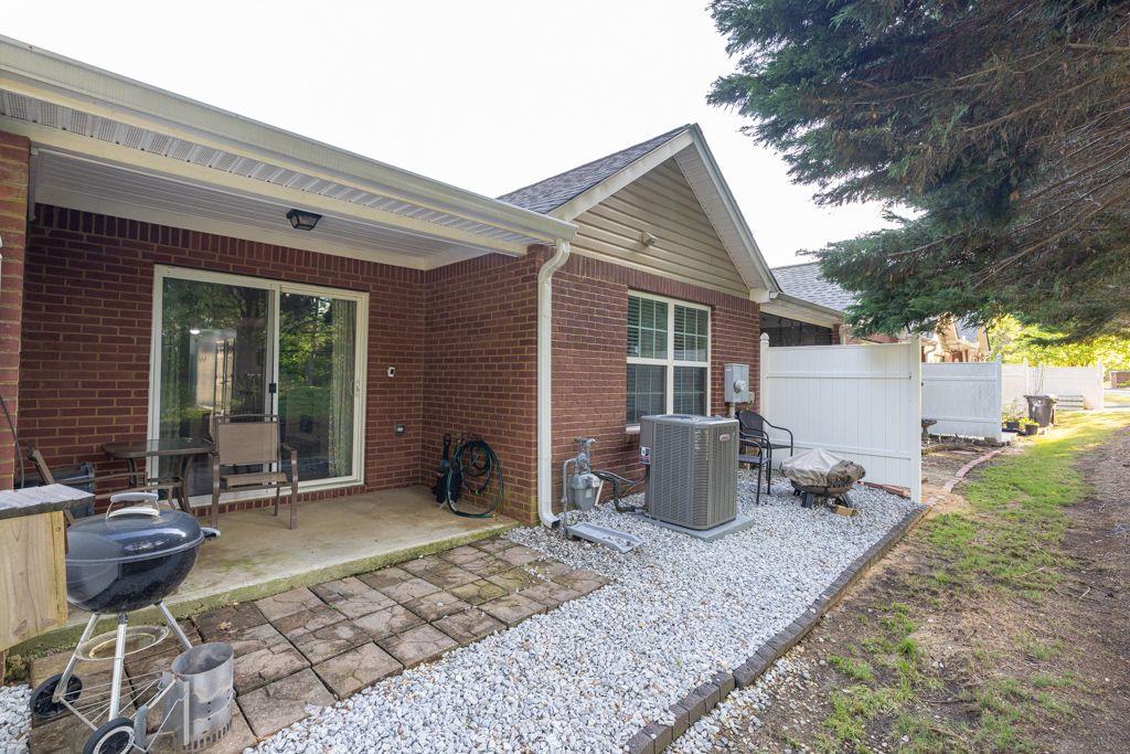 233 Tara Commons Walk Loganville, GA 30052 - Photo 43 of 52 a backyard of a house with barbeque oven table and chairs
