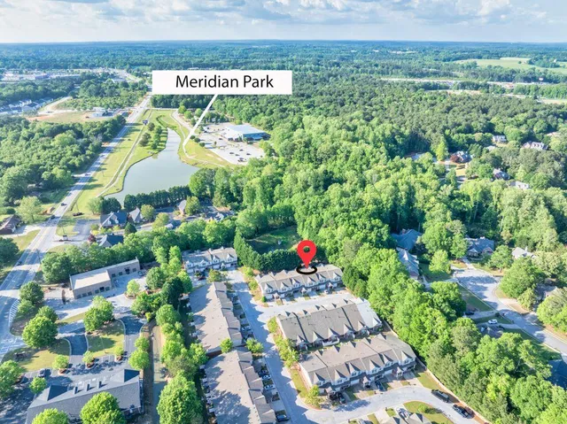 an aerial view of a house with a yard and garden in the back
