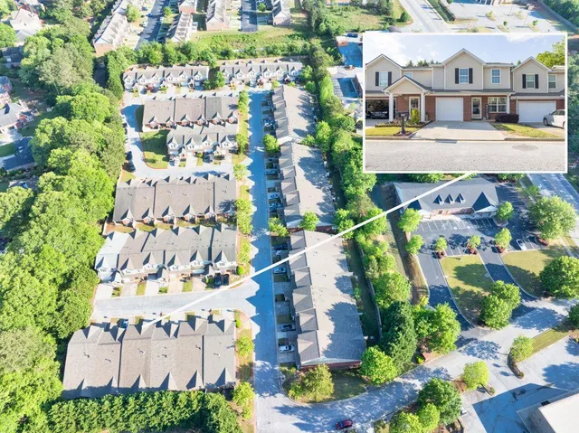 an aerial view of a house with a yard and potted plants