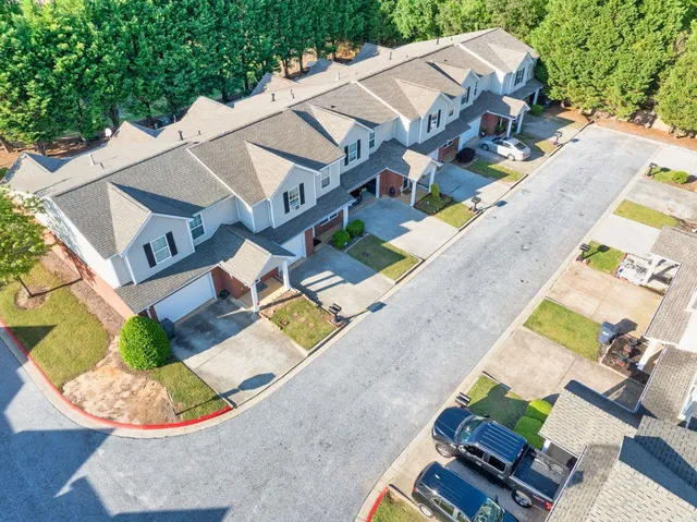 an aerial view of a house with a yard