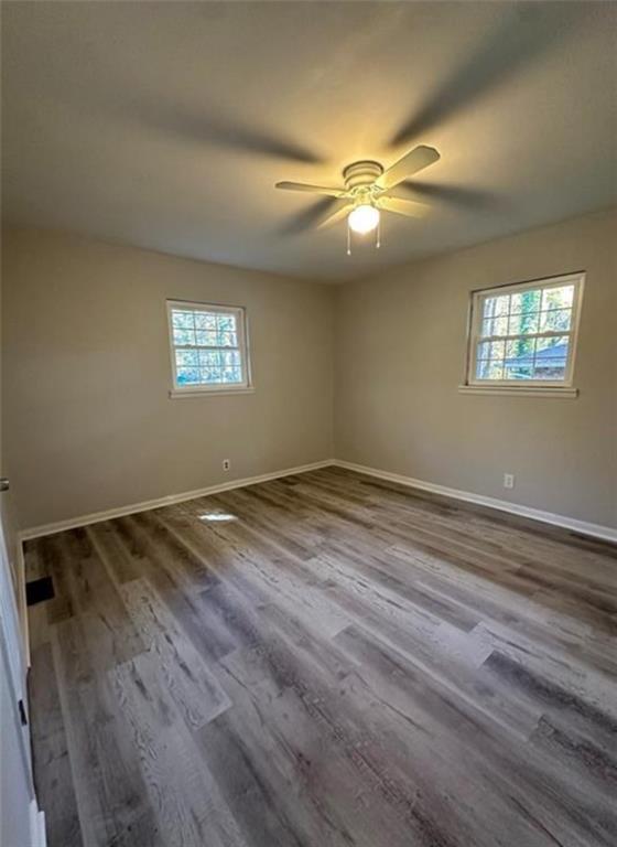 4510 Burks Road Forest Park, GA 30297 - Photo 4 of 8 wooden floor in an empty room with a window