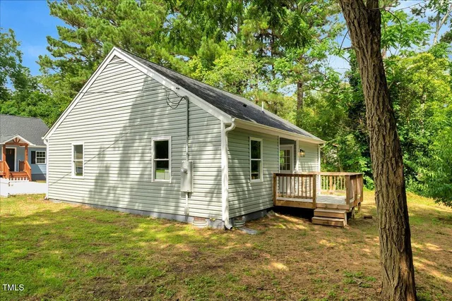 a view of house with backyard