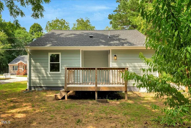 a view of a house with a yard and sitting area