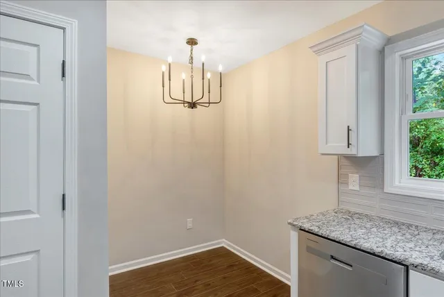 a kitchen with stainless steel appliances granite countertop a sink a stove a microwave and wooden cabinets