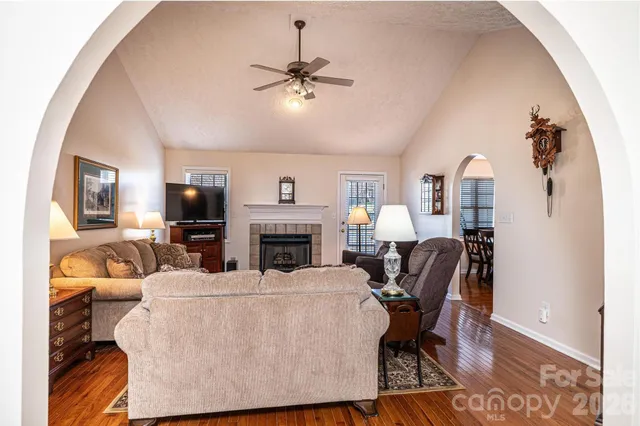 a living room with furniture a fireplace and a flat screen tv