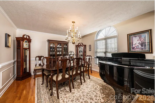 a view of a dining room with furniture and chandelier