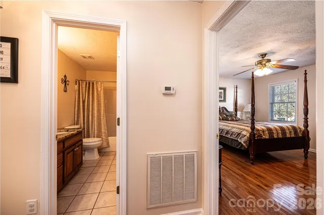 a bedroom with a bed and a mirror