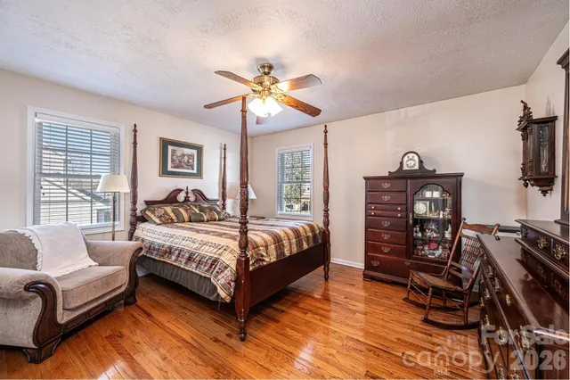 a bedroom with a bed a couch and a chandelier