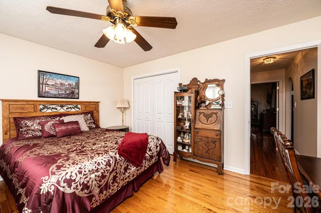 a bedroom with a large bed and a flat tv screen