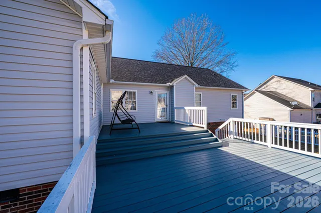 a view of a house with wooden deck