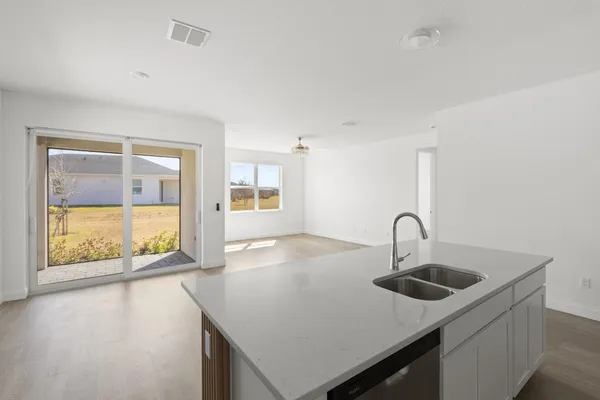 a kitchen with a sink a stove and window