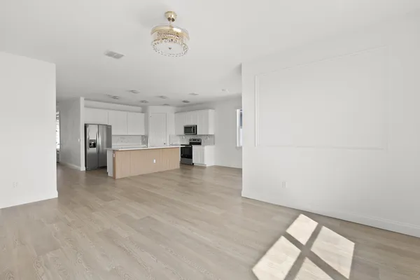 a view of a kitchen with a sink and a refrigerator