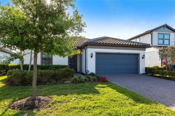 a front view of house with a garden