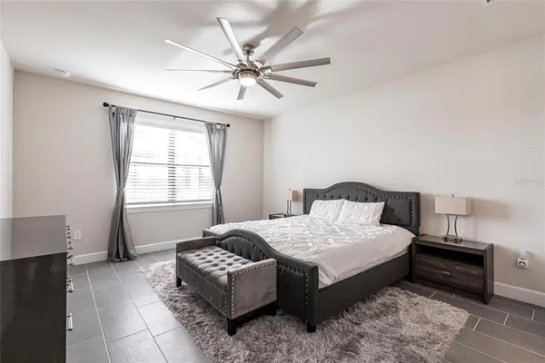 a bedroom with a large bed and a chandelier
