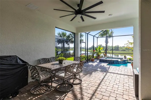 a dining room with furniture and a potted plant