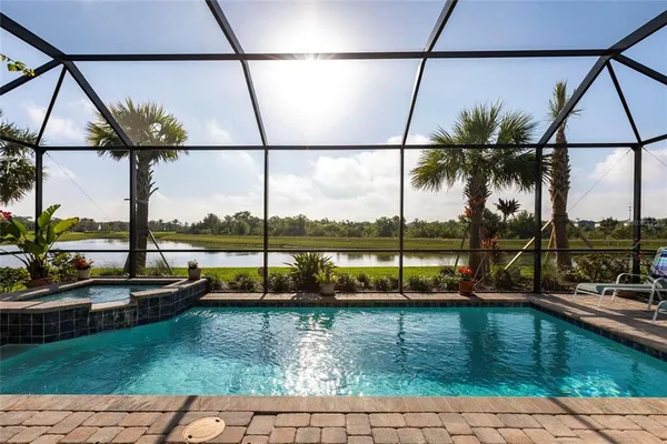 a view of swimming pool with a lounge chairs