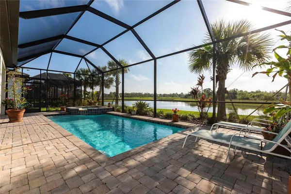 a view of a house with backyard and sitting area