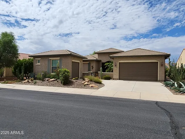 a view of a house with outdoor space and a car parked in front of it