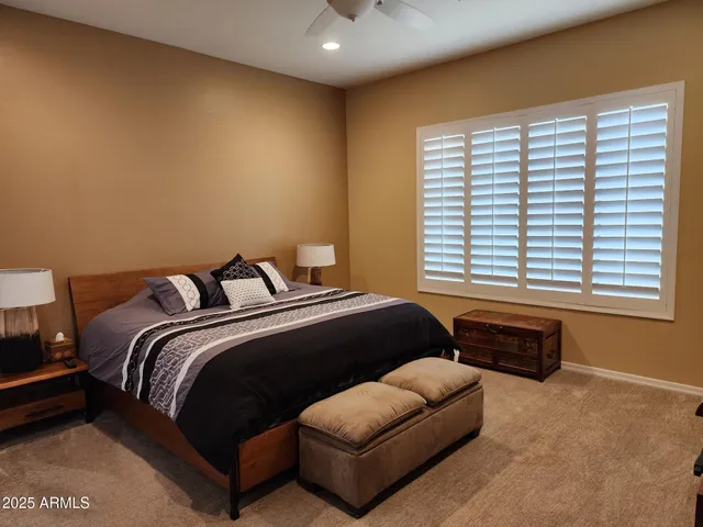 a bedroom with a bed and a couch