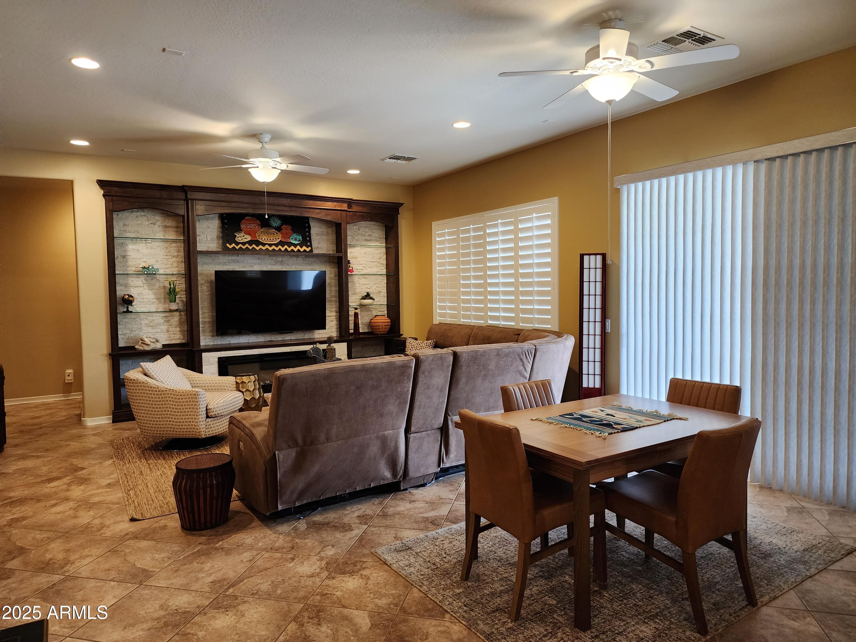 20002 North 269th Drive Buckeye, AZ 85396 - Photo 2 of 29 a living room with furniture and a flat screen tv