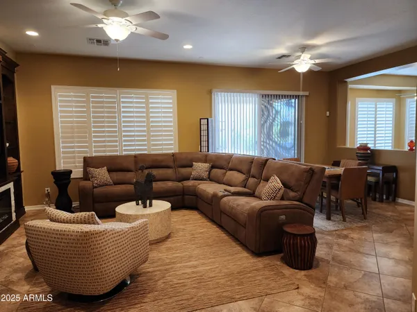 a living room with furniture and a chandelier