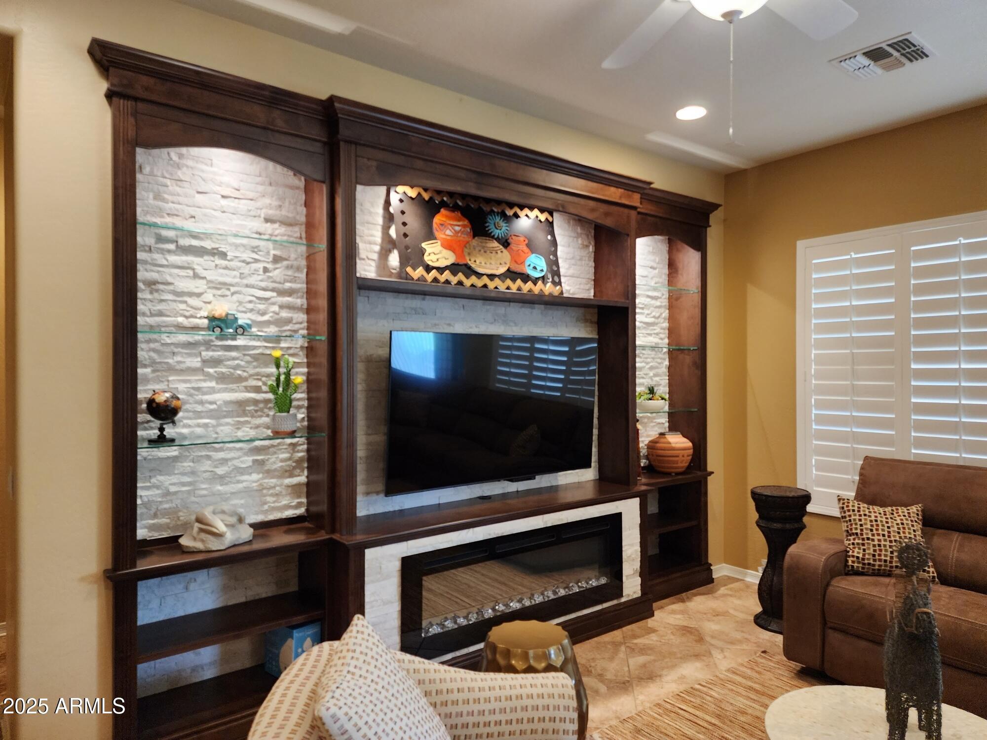 20002 North 269th Drive Buckeye, AZ 85396 - Photo 5 of 29 a living room with fireplace furniture and a flat screen tv