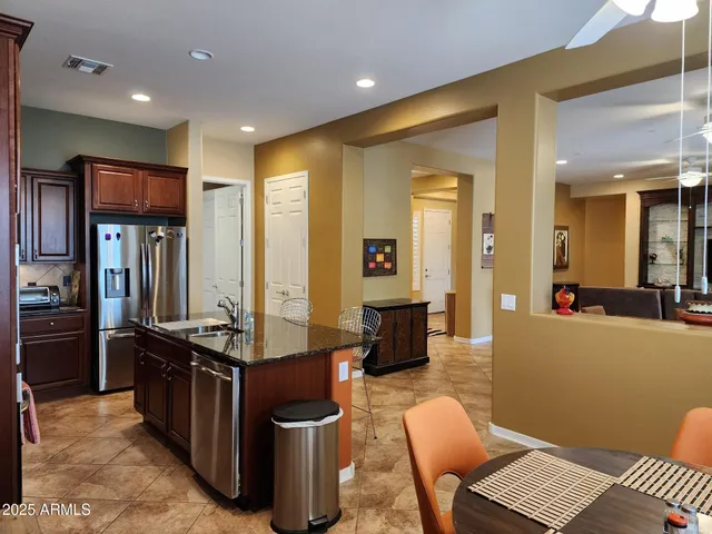 a living room with furniture a large window with kitchen view